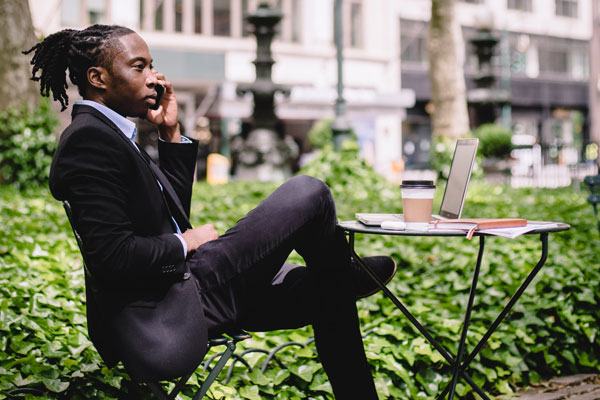 businessman sitting at a table and talking on the phone